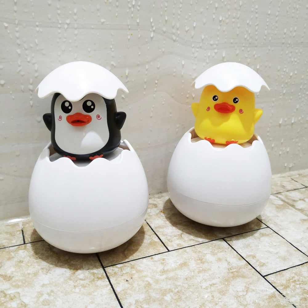 Cute duck and penguin bath toys with water spraying action for kids aged 0-6.