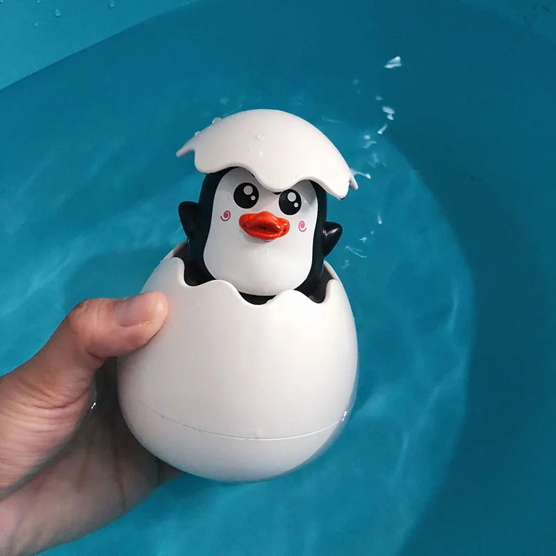 Cute duck and penguin bath toys with water spraying action for kids aged 0-6.