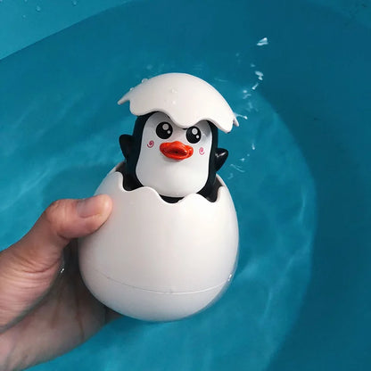 Cute duck and penguin bath toys with water spraying action for kids aged 0-6.