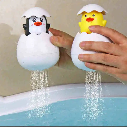 Cute duck and penguin bath toys with water spraying action for kids aged 0-6.