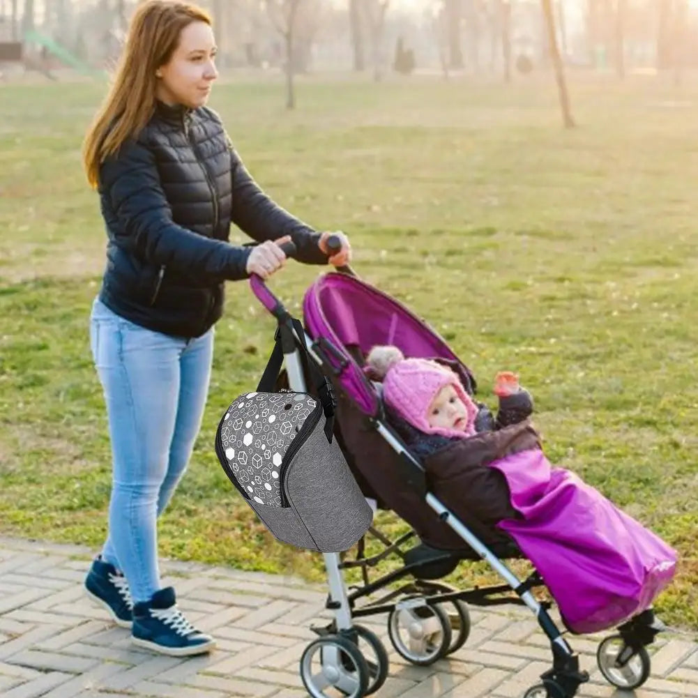 Breast milk cooler bag with insulated lining, ice pack, and adjustable strap.