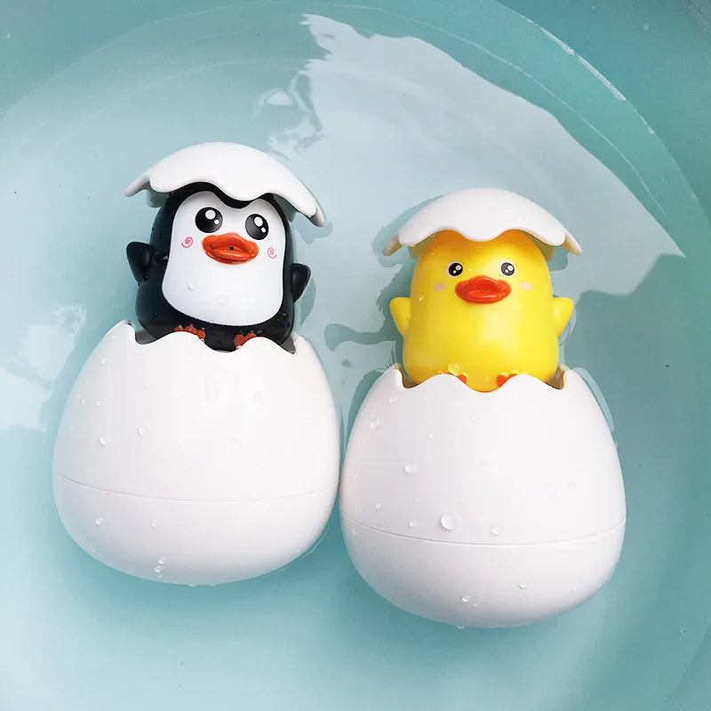 Cute duck and penguin bath toys with water spraying action for kids aged 0-6.