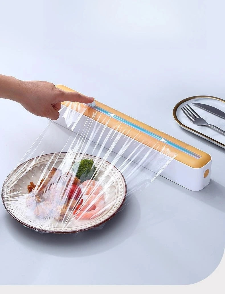 Plastic cling wrap dispenser with cutter, anti-drop design, fits up to 35 cm wide wraps.