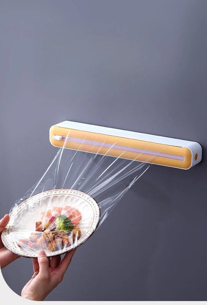 Plastic cling wrap dispenser with cutter, anti-drop design, fits up to 35 cm wide wraps.