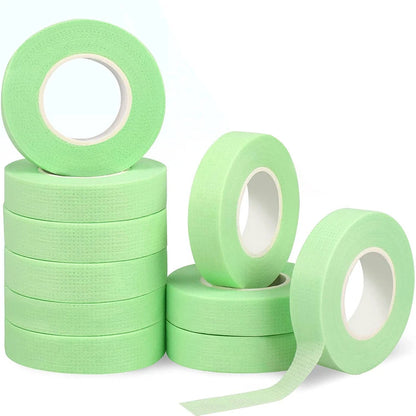 Multiple rolls of colorful micropore eyelash tape for lash extension and lifting, featuring pink, green, white, blue, and purple colors.