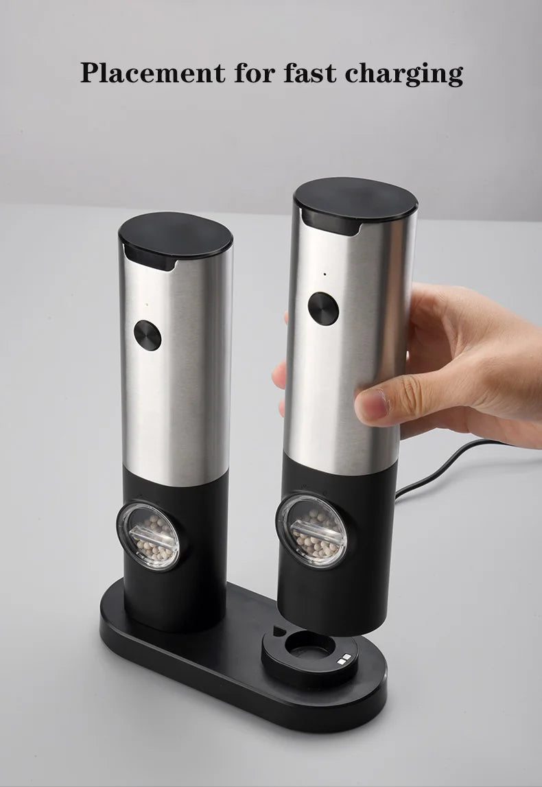 Close-up of USB rechargeable electric salt and pepper grinder set with LED light, stainless steel body, and adjustable coarseness knob. Perfect for precise seasoning in the kitchen.