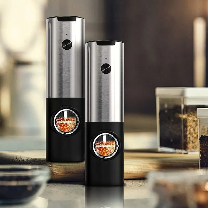 Close-up of USB rechargeable electric salt and pepper grinder set with LED light, stainless steel body, and adjustable coarseness knob. Perfect for precise seasoning in the kitchen.