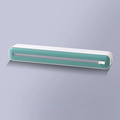 Plastic cling wrap dispenser with cutter, anti-drop design, fits up to 35 cm wide wraps.