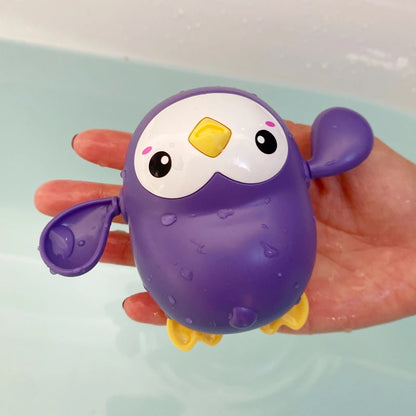 Cute duck and penguin bath toys with water spraying action for kids aged 0-6.