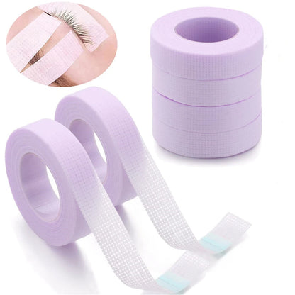 Multiple rolls of colorful micropore eyelash tape for lash extension and lifting, featuring pink, green, white, blue, and purple colors.