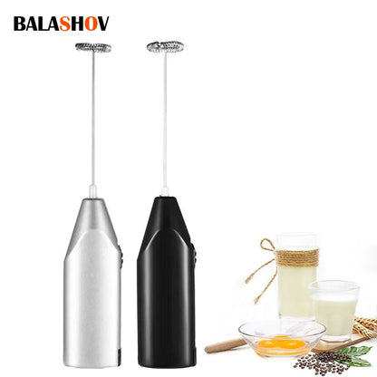 Handheld electric milk frother with stainless steel spring, black and silver. Battery-powered for efficient mixing of milk, coffee, and eggs.