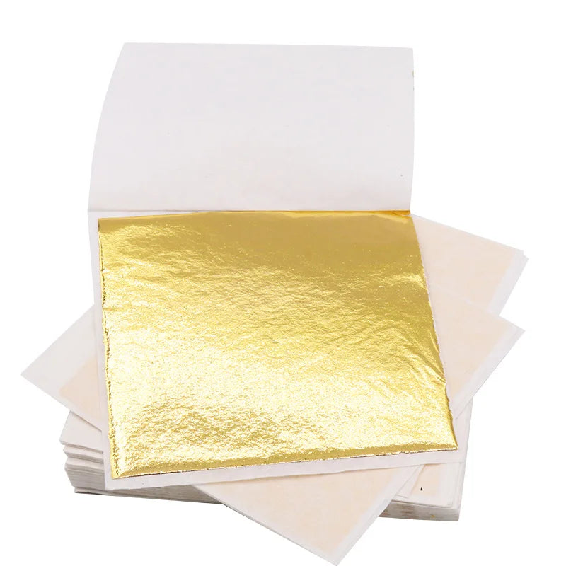 100 sheets of imitation gold and silver foil paper leaf for DIY art and craft. Each sheet measures 8.5x8cm, ideal for birthday parties, weddings, and cake decorations