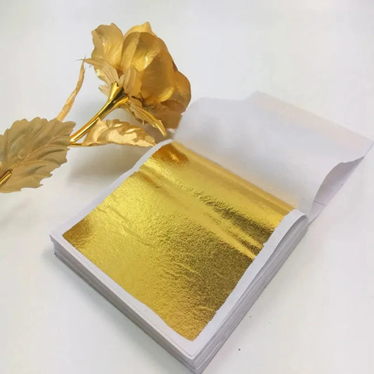 100 sheets of imitation gold and silver foil paper leaf for DIY art and craft. Each sheet measures 8.5x8cm, ideal for birthday parties, weddings, and cake decorations