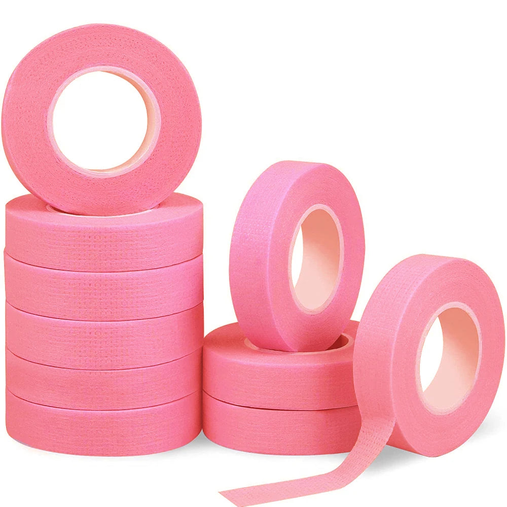 Multiple rolls of colorful micropore eyelash tape for lash extension and lifting, featuring pink, green, white, blue, and purple colors.