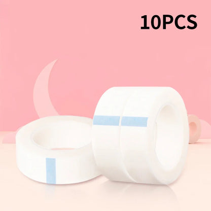 Multiple rolls of colorful micropore eyelash tape for lash extension and lifting, featuring pink, green, white, blue, and purple colors.